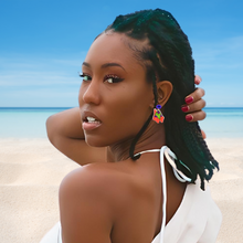 Load image into Gallery viewer, A model on the beach looking back and wearing a dangling Patrick Star earring