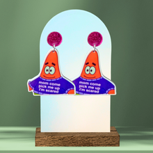 Load image into Gallery viewer, A green background with earrings featuring Patrick Star that say "mom come pick me up i'm scared" on his sweater