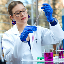 Load image into Gallery viewer, A female scientist wearing Bill Nye the Science Guy earrings