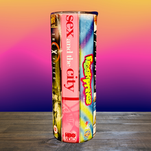 Load image into Gallery viewer, A 20 oz stainless steel insulated tumbler featuring a vinyl wrap of VHS covers from iconic '90s TV shows, including Friends, The Sopranos, The Fresh Prince of Bel-Air, and Sex and the City. Comes with a lid and reusable straw, perfect for nostalgic TV lovers.