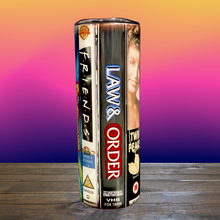 Load image into Gallery viewer, A 20 oz stainless steel insulated tumbler featuring a vinyl wrap of VHS covers from iconic '90s TV shows, including Friends, The Sopranos, The Fresh Prince of Bel-Air, and Sex and the City. Comes with a lid and reusable straw, perfect for nostalgic TV lovers.