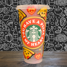 Load image into Gallery viewer, A 16 oz reusable Starbucks-compatible cold cup with a marble-changing design that shifts to orange, red, and blue when filled with cold liquid. The cup features a playful vinyl wrap reading "You Have a Pizza My Heart" and comes with a clear plastic lid and reusable straw, ideal for iced coffee lovers.