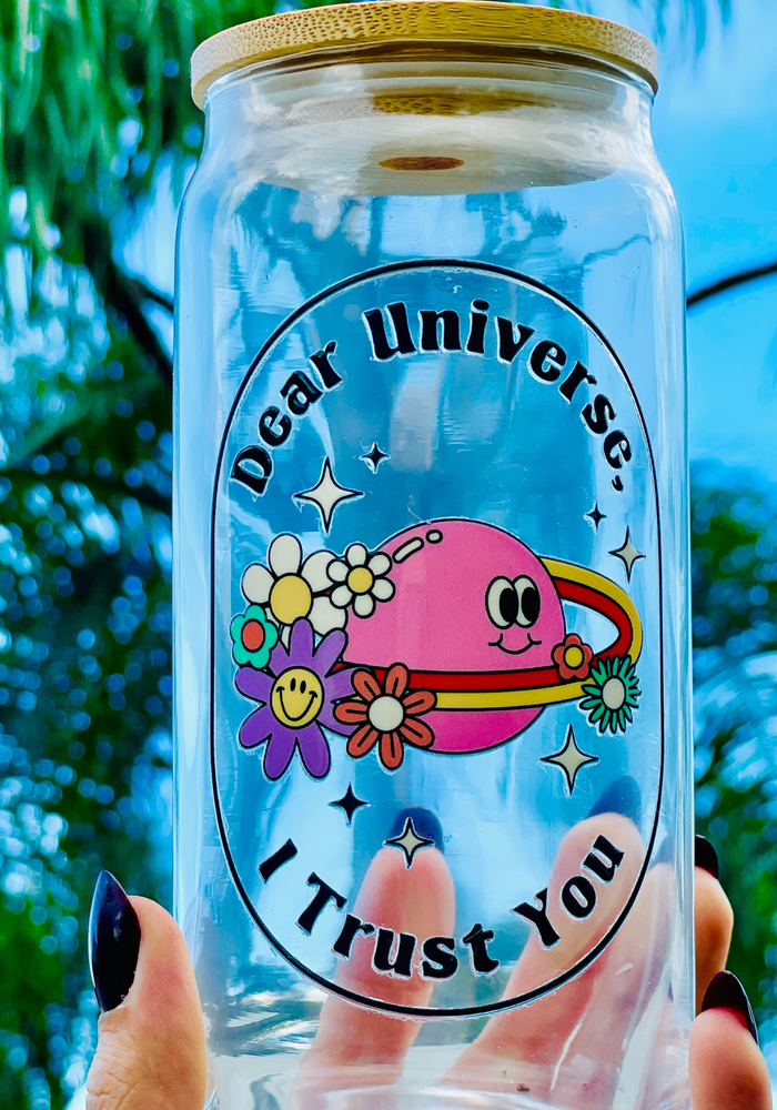 A 16oz BPA-free glass cup with a UVDTF design featuring a pink planet with flowers, sparkles, and the phrase