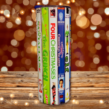 Load image into Gallery viewer, A 20 oz stainless steel insulated Christmas Movie Tumbler featuring a colorful design with movie covers including The Santa Clause, The Grinch, Four Christmases, National Lampoon Christmas Vacation and Elf. Comes with a clear lid, metal straw, and straw cleaner, perfect for hot and cold drinks.