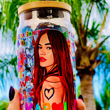 Load image into Gallery viewer, A 16 oz glass cup with a colorful Karol G-inspired UVDTF wrap featuring vibrant symbols, designs, and playful details. Includes a bamboo lid and reusable glass straw, perfect for cold drinks. BPA-free and handwash only.