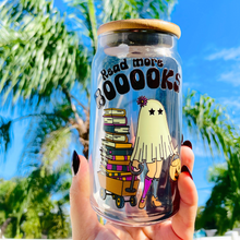 Load image into Gallery viewer, A 16 oz glass cup featuring a cute ghost design pulling a wagon full of books with the text "Read More BOOks." Includes a bamboo lid decorated with tiny ghosts and a reusable glass straw, ideal for book lovers.