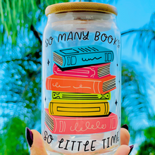 Load image into Gallery viewer, A 16oz BPA-free glass cup with a UVDTF wrap featuring colorful stacked books and the phrase "So Many Books, So Little Time." Includes a bamboo lid and reusable glass straw, perfect for book lovers and cold drinks.