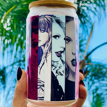 Load image into Gallery viewer, A 16oz BPA-free glass cup with a UVDTF wrap featuring Taylor Swift's iconic eras, complete with a bamboo lid and reusable glass straw. Perfect for Swifties and cold drinks.