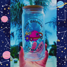 Load and play video in Gallery viewer, A 16oz BPA-free glass cup with a UVDTF design featuring a pink planet with flowers, sparkles, and the phrase "Dear Universe, I Trust You," complete with a bamboo lid and reusable glass straw.
