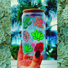 Load and play video in Gallery viewer, A 16 oz glass cup featuring a colorful succulent and cactus design with a bamboo lid and reusable glass straw. Perfect for cold drinks, eco-friendly, and BPA-free. Handwash only.