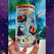 Load and play video in Gallery viewer, A 16 oz glass cup featuring a Harry Potter-inspired UVDTF wrap with wands, spellbooks, lightning bolts, and the Sorting Hat. Includes a bamboo lid and reusable glass straw, perfect for cold drinks. BPA-free and handwash only.