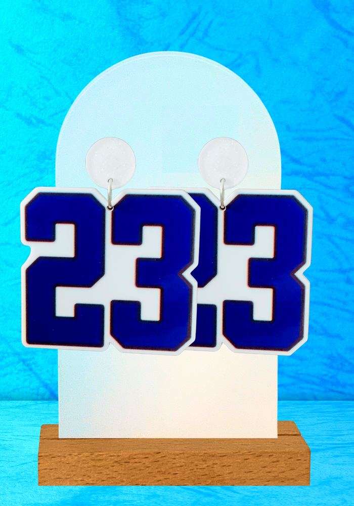 Earrings featuring a blue '23' in Varsity font in front of a blue backdrop
