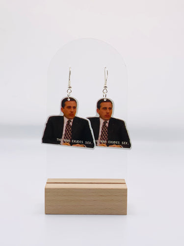 Michael Scott Cheese Ball Bliss Earrings from The Office, featuring Michael with cheese dust on his face and the quote 'The man exudes s*x' by Holly, capturing a humorously love-filled moment