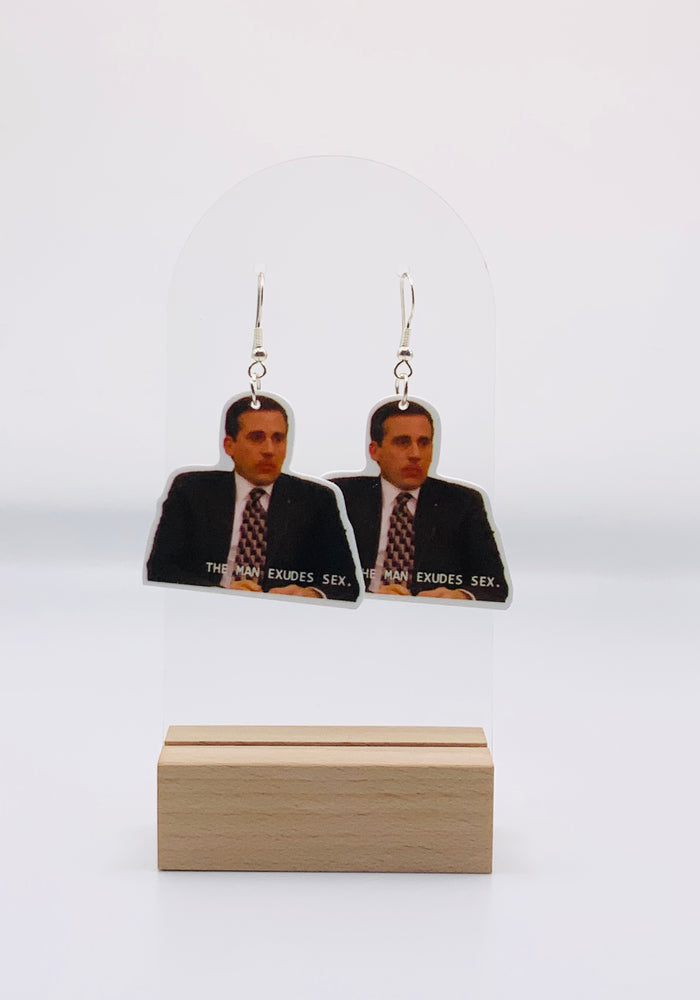 Michael Scott Cheese Ball Bliss Earrings from The Office, featuring Michael with cheese dust on his face and the quote 'The man exudes s*x' by Holly, capturing a humorously love-filled moment