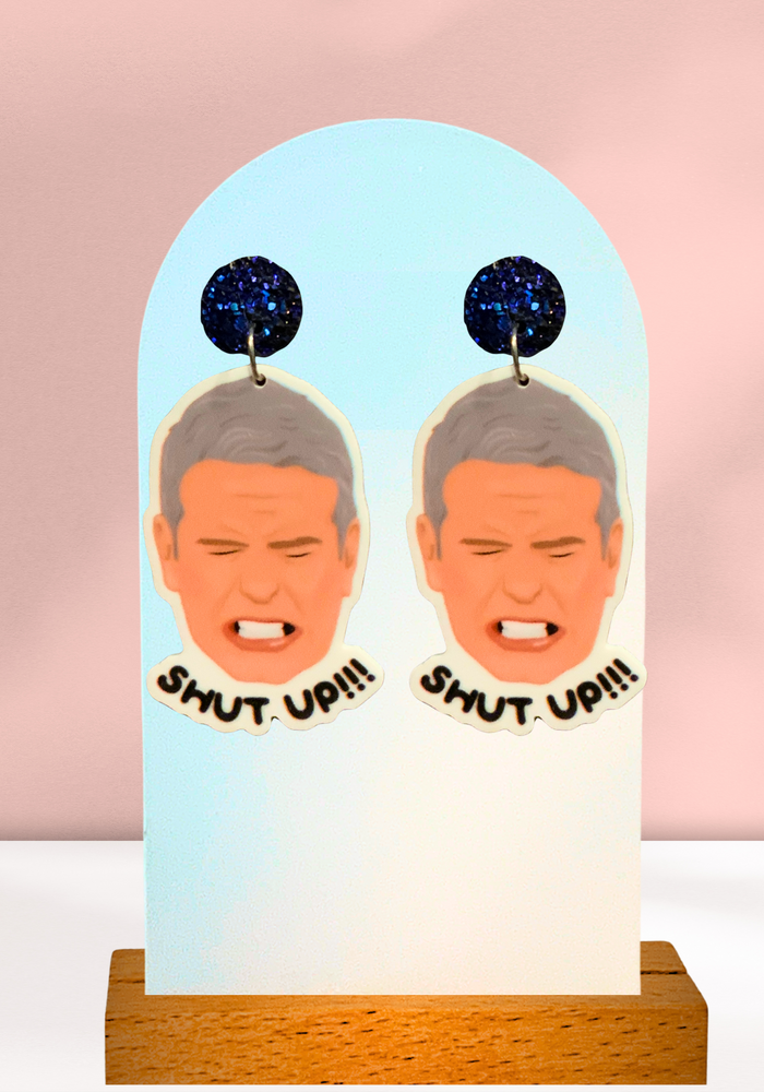 Earrings featuring a drawing of Andy Cohen from the Real Housewives of New York reunion yelling 