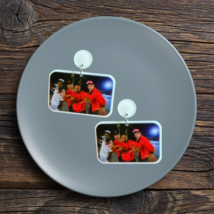 A trinket dish with New Girl earrings featuring Winston, Nick, Coach and Schmidt posing in hats and jackets