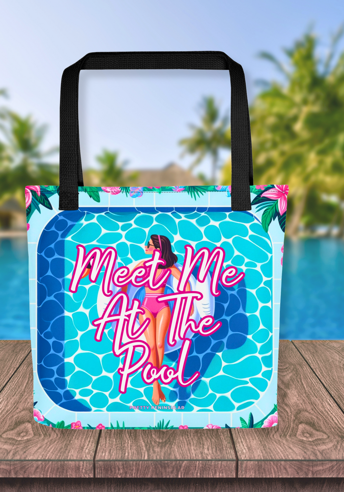 Bright and playful 'Meet Me At The Pool' tote bag featuring an illustration of a woman on a swan floatie in a pool, complete with a bold, inviting logo, set against a vibrant poolside scene for a perfect summer accessory.