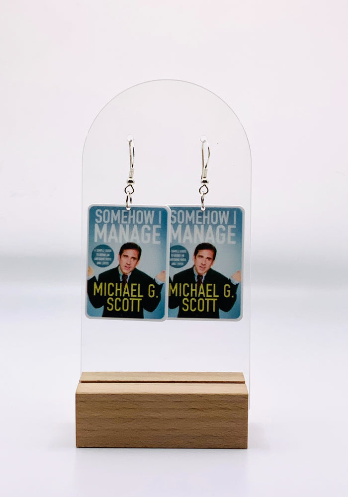 Michael Scott 'Somehow I Manage' book cover earrings from 'The Office', featuring iconic faux book design, crafted from lightweight acrylic and resin on hypoallergenic hooks