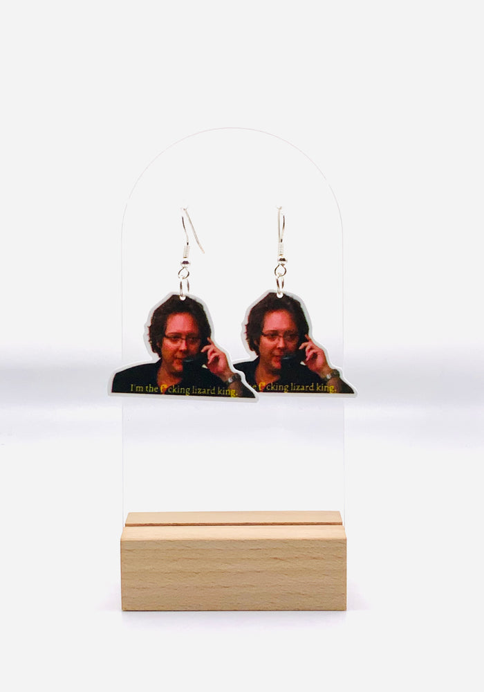 Earrings featuring the iconic smirk of Robert California from 'The Office', emblazoned with his audacious claim: 'I'm the f*cking lizard king.' 