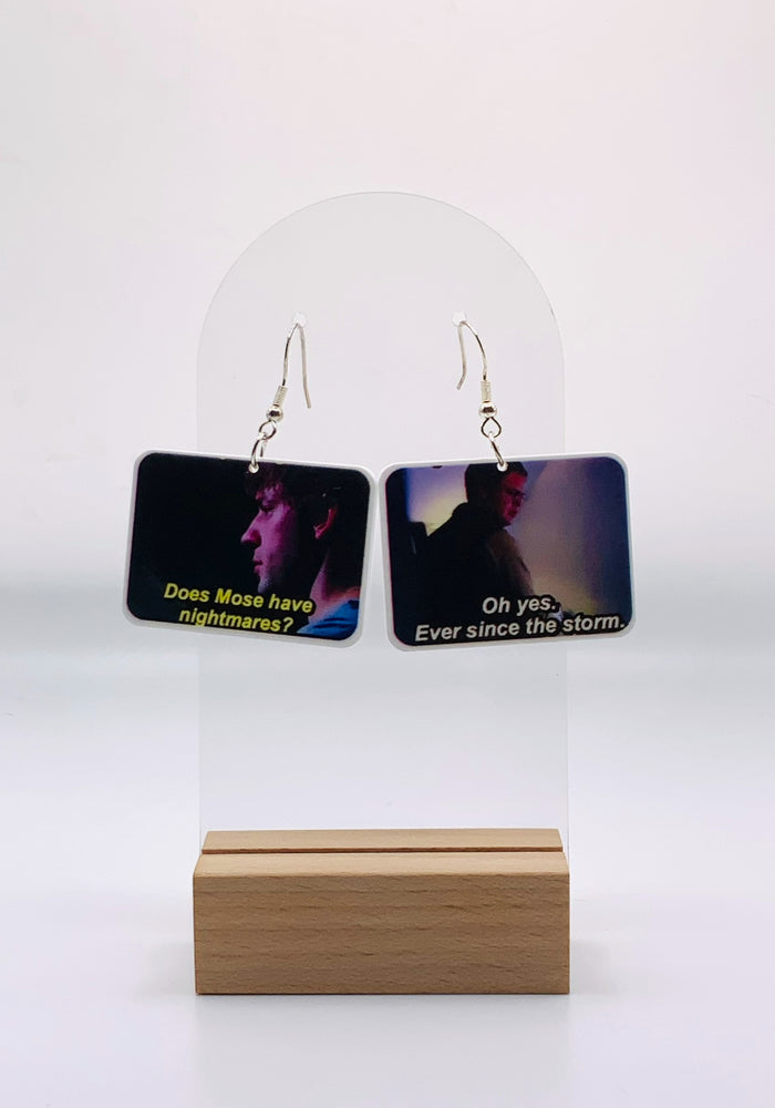 Earrings immortalizing the intriguing exchange between Jim and Dwight about Mose's sleep patterns, set against the backdrop of Schrute Farms. These pieces capture the moment with 'Does Mose have nightmares?' and Dwight's somber 'Oh yes, ever since the storm,' 