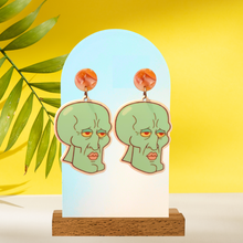 Load image into Gallery viewer, Handsome Squidward earrings photographed on a yellow background
