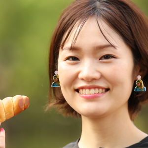 A model wearing Lizzie Mcguire earrings saying "I'd eat carbs if an italian boy bought them for me"