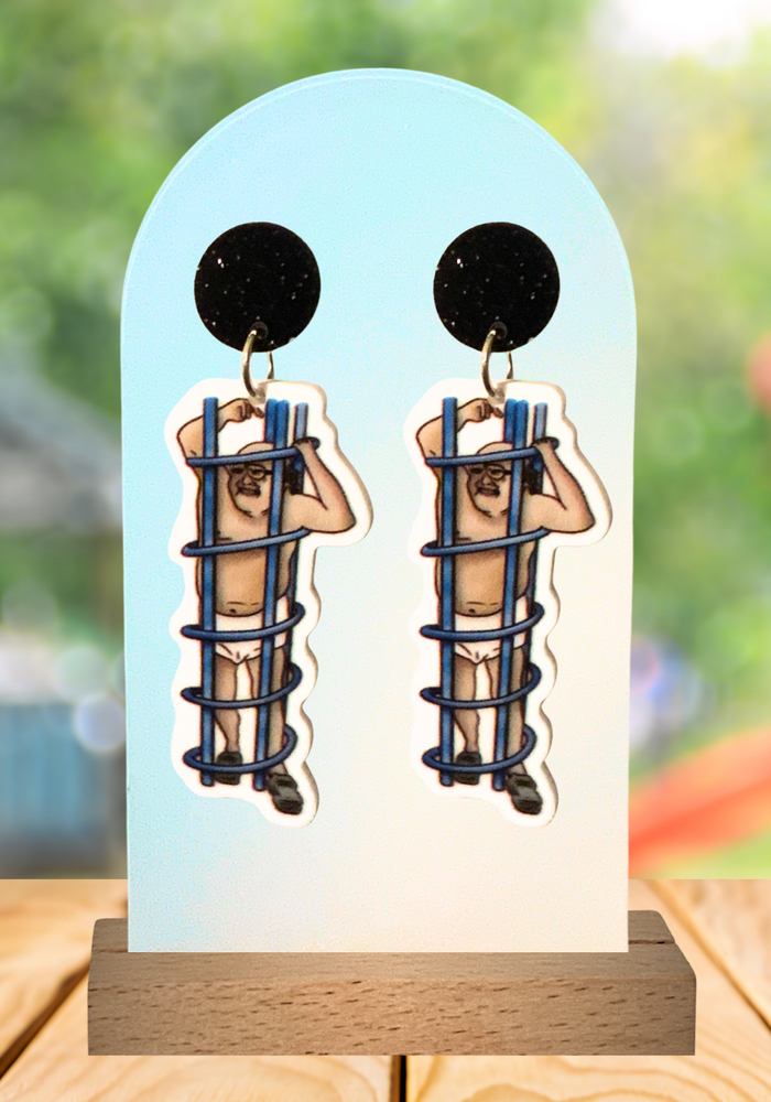 Earrings featuring Frank Reynolds stuck in a  playground coil with a playground background