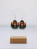 Earrings showcasing Dwight Schrute from 'The Office' eerily wearing the face of a CPR dummy, reminiscent of a scene from 'Silence of the Lambs.' The caption 'It's pretty realistic' is displayed underneath, capturing the bizarre and humorous moment in vivid detail