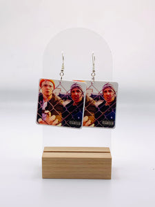 Earrings showcasing Michael Scott and Dwight as would-be rappers on the mock album cover “Straight Outta Scranton,” complete with a humorous ‘Parental Advisory’ label.