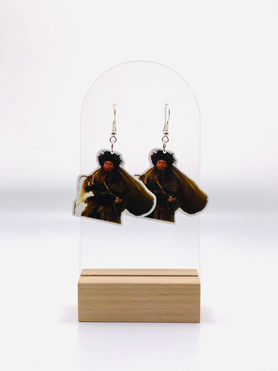 Earrings depicting Dwight Schrute from 'The Office' in his Belsnickel attire, complete with traditional garb and ready to deem your year 'Impish' or 'Admirable