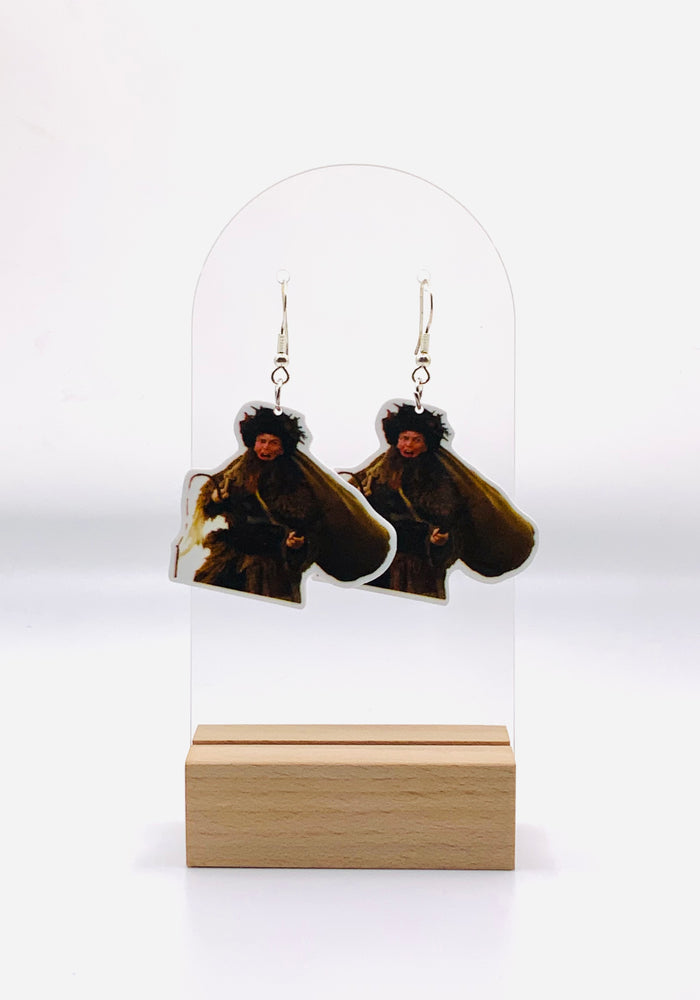 Earrings depicting Dwight Schrute from 'The Office' in his Belsnickel attire, complete with traditional garb and ready to deem your year 'Impish' or 'Admirable