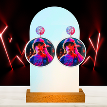 Load image into Gallery viewer, A red neon background with earrings featuring Dustin from Stranger Things
