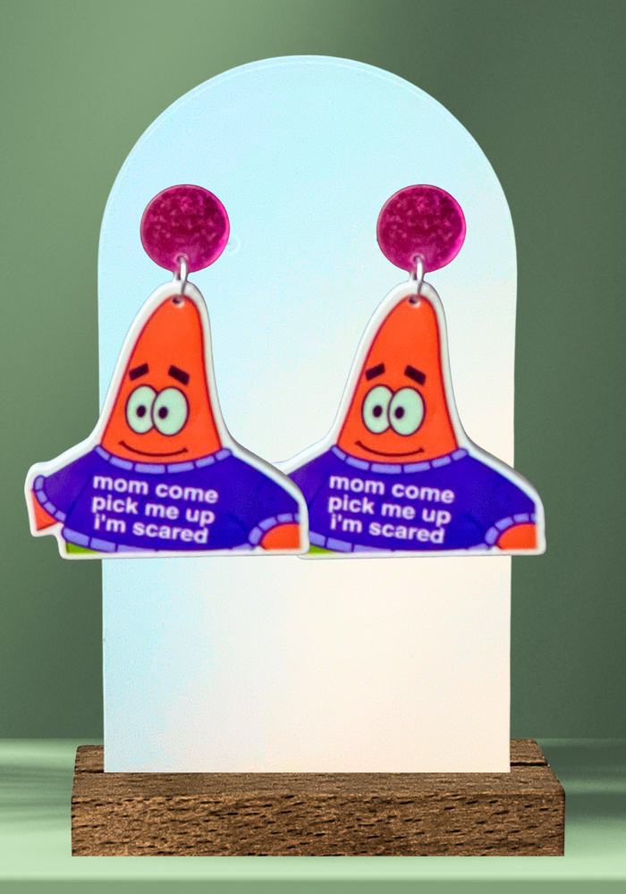 A green background with earrings featuring Patrick Star that say 