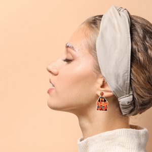 A model wearing earrings featuring Tia and Tamera from Sister Sister