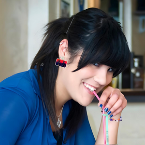 A model sipping a straw wearing earrings featuring Mac and Charlie from "It's Always Sunny in Philadelphia" performing an "ocular patdown."