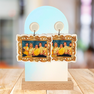 Earrings on an arched stand featuring a framed photo of the Always Sunny in Philadelphia cast