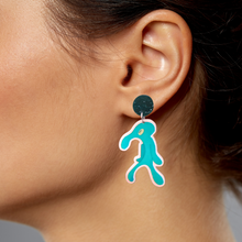 Load image into Gallery viewer, Squidward &#39;Bold and Brash&#39; earring hanging off of an ear
