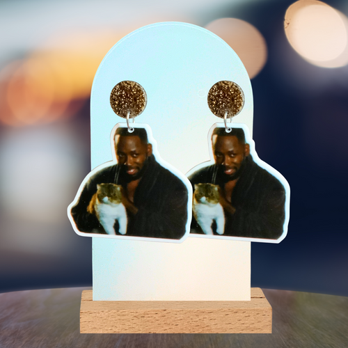 Earrings featuring Winston from New Girl in his robe holding Ferguson the cat