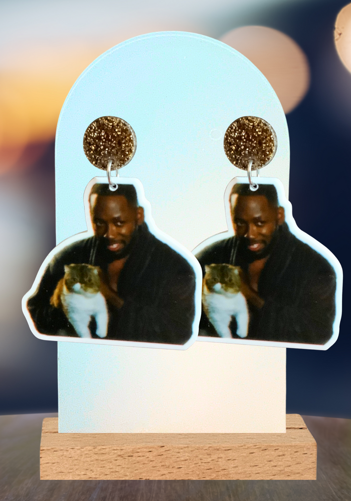 Earrings featuring Winston from New Girl in his robe holding Ferguson the cat