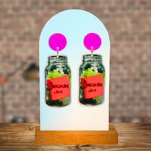 Load image into Gallery viewer, Earrings with neon pink studs and a dangling “Douchebag Jar” earring from New Girl
