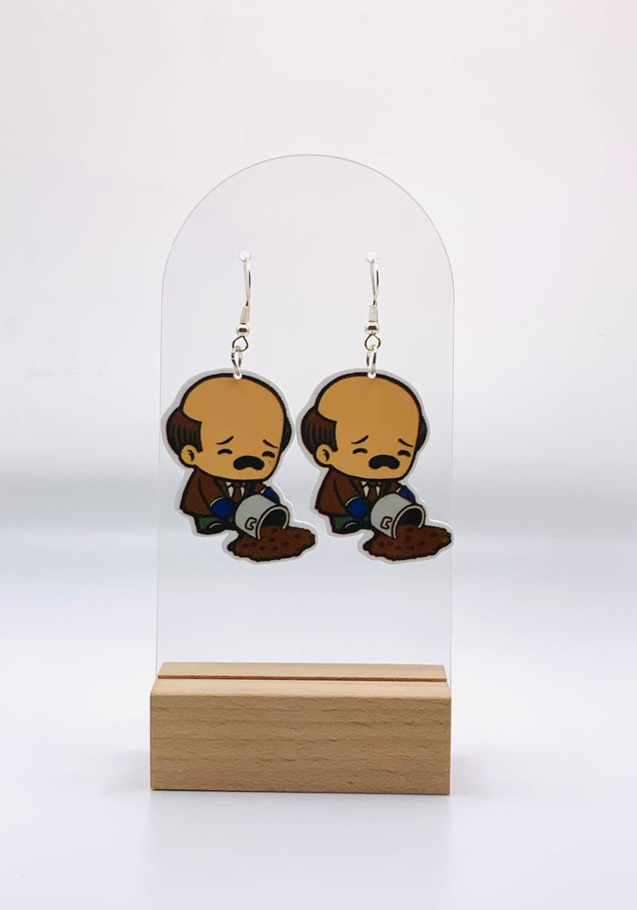 Colorful earrings depicting a cartoon Kevin Malone from “The Office” with tears in his eyes, trying to scoop up his spilled chili from the floor - a humorous homage to the famous ‘Chili Spill’ scene.