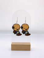 Colorful earrings depicting a cartoon Kevin Malone from “The Office” with tears in his eyes, trying to scoop up his spilled chili from the floor - a humorous homage to the famous ‘Chili Spill’ scene.