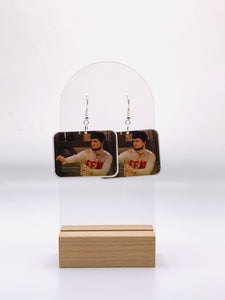 Earrings depicting Mose Schrute from "The Office" in a fighting stance, poised to defend Schrute Farms with beet-fueled dominance. Featuring Mose in his iconic 'Fear' shirt