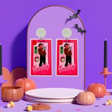 Load image into Gallery viewer, Earrings featuring Freddy Krueger in a Barbie-style box, with an Elm Street sign and alarm clock, ideal for fans of horror movies and playful Halloween fashion.
