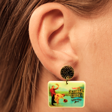 Load image into Gallery viewer, A close up of an ear wearing Schitt&#39;s Creek Town Billboard earrings
