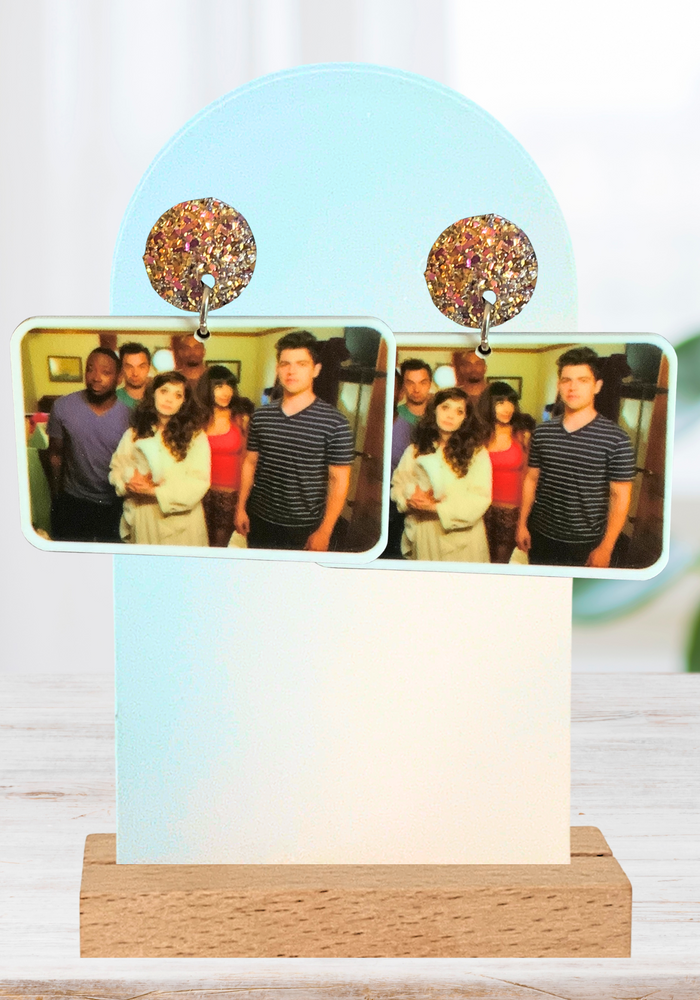 Earrings featuring a photo of the New Girl cast after being rescued from their cruise room