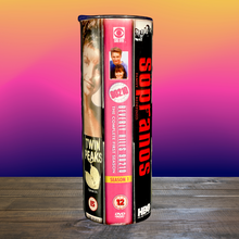 Load image into Gallery viewer, A 20 oz stainless steel insulated tumbler featuring a vinyl wrap of VHS covers from iconic &#39;90s TV shows, including Friends, The Sopranos, The Fresh Prince of Bel-Air, and Sex and the City. Comes with a lid and reusable straw, perfect for nostalgic TV lovers.
