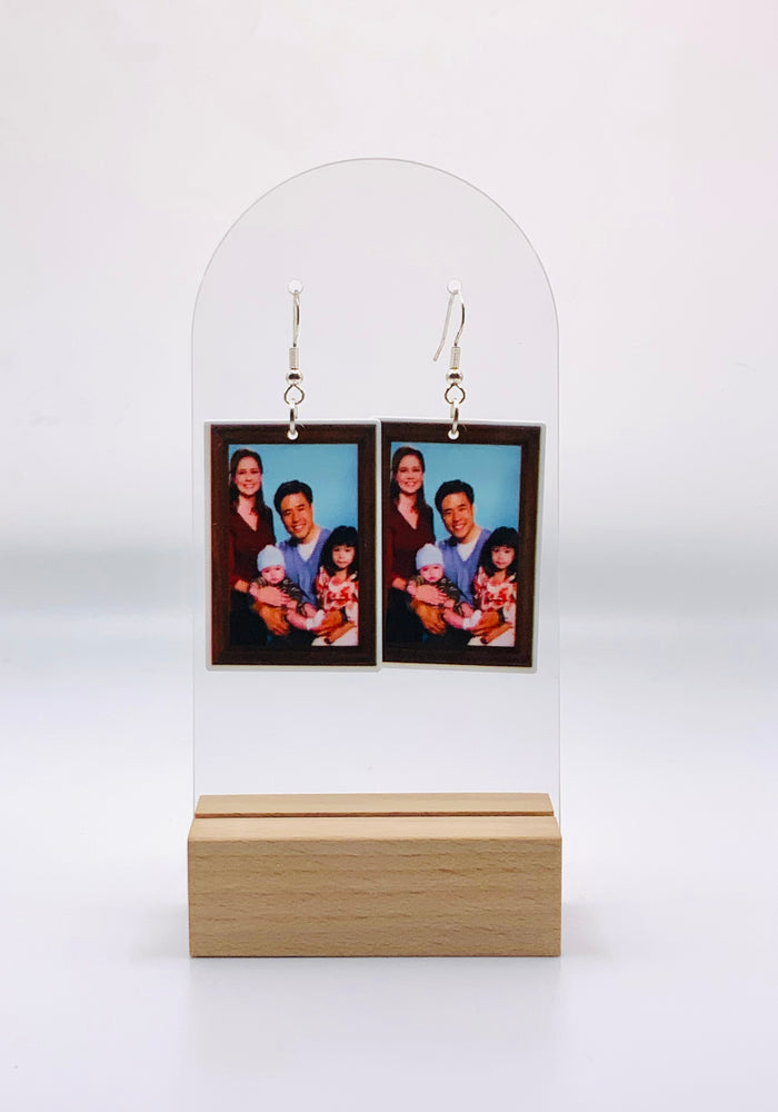 'Asian Jim' prank family photo earrings from 'The Office' featuring Randall Park, encased in acrylic, hypoallergenic hooks, perfect for fans.