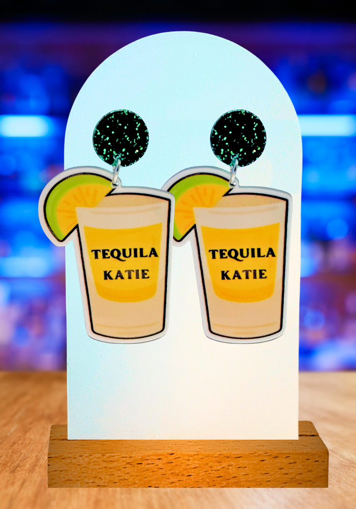 Earrings featuring a cartoon shot glass with 