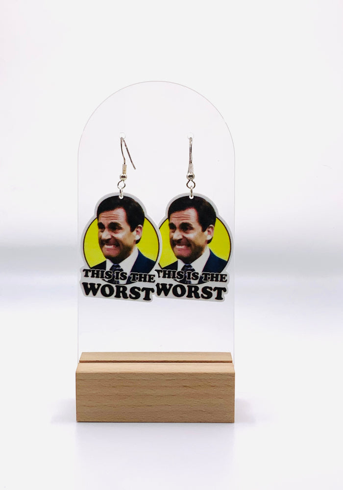 Earrings featuring Michael Scott's unforgettable face of dismay in vibrant yellow, accompanied by his famous 'this is the worst' quote